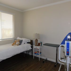 Amparo Senior Care LLC bedroom with hoyer lift.JPG