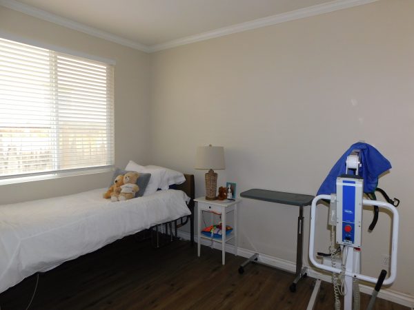 Amparo Senior Care LLC bedroom with hoyer lift.JPG