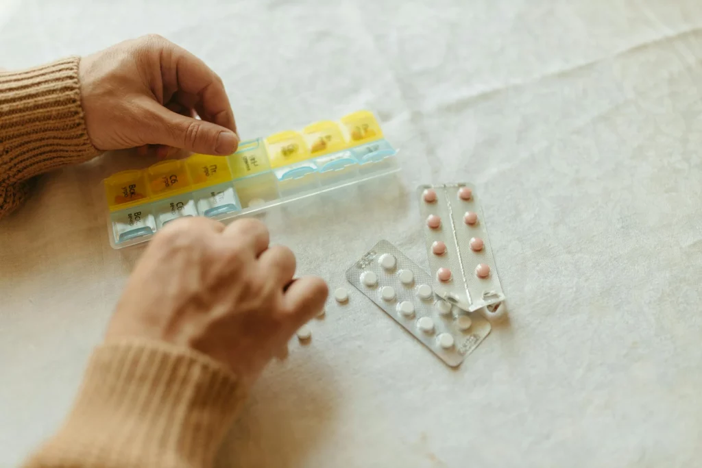 An elderly person sorting medications